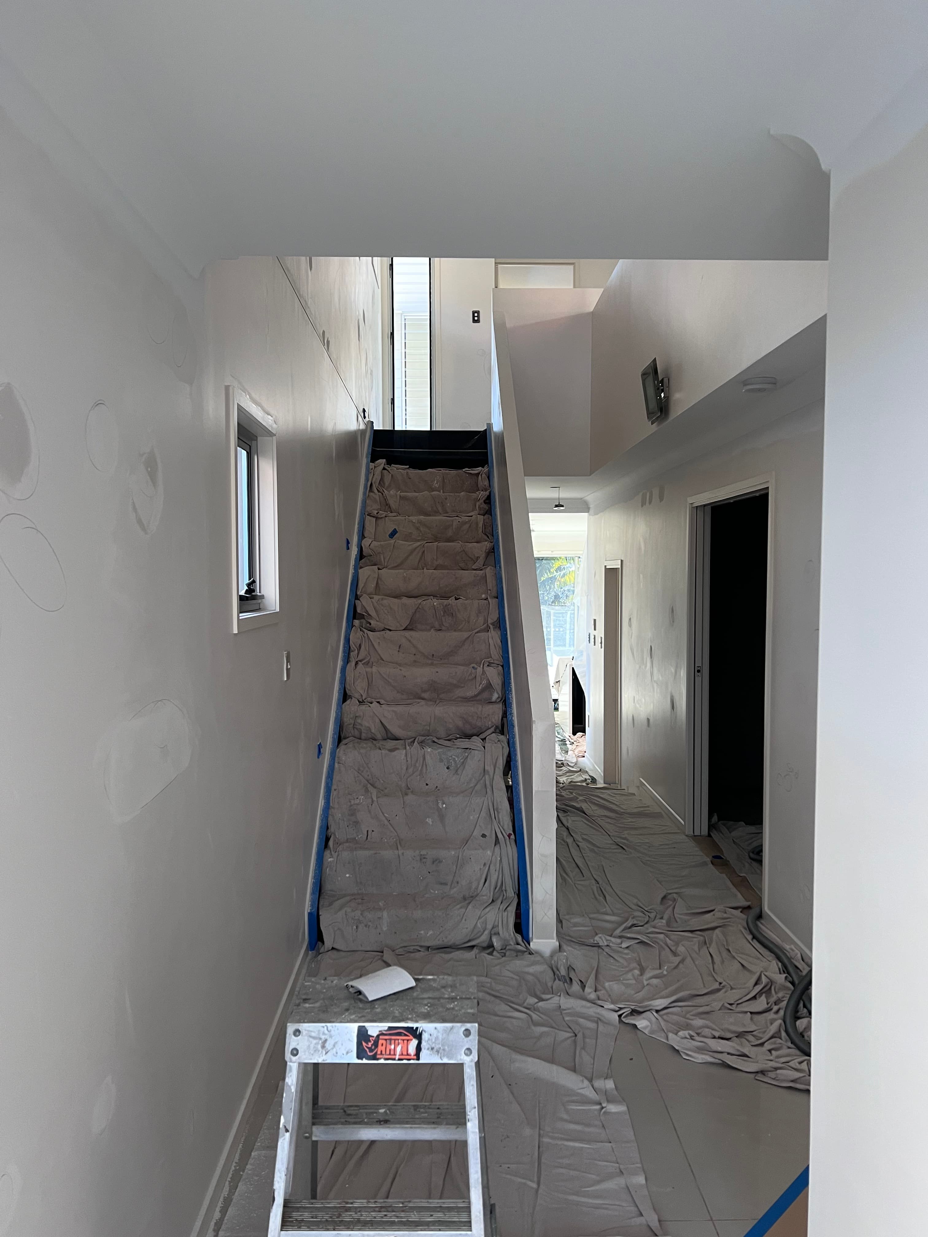 Interior painting Brisbane, room during preparation phase with drop sheets